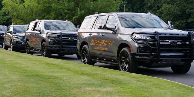 FILE- Several Cobb County police cruisers parked in a row. Jacqun Brown ended up incarcerated at the very jail where he was working after he allegedly beat an inmate.