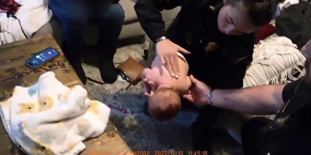 Officer Alexis Callaway administers a lifesaving technique on a choking infant in Georgia.