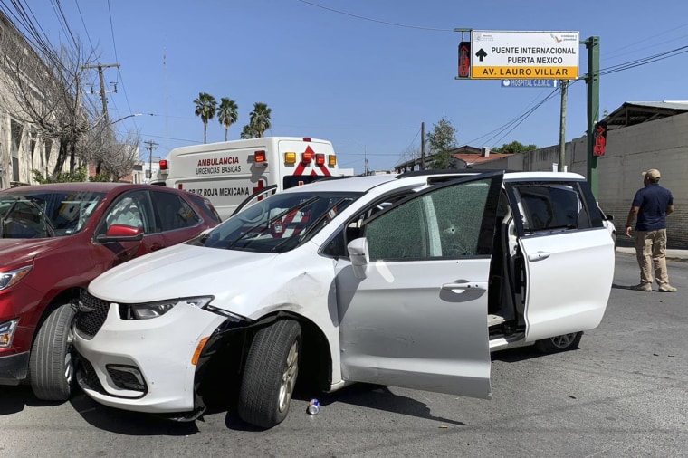 A member of the Mexican security forces stands next to a white minivan with North Carolina plates and several bullet holes, at the crime scene where gunmen kidnapped four U.S. citizens who crossed into Mexico from Texas, Friday, March 3, 2023. Mexican President Andres Manuel Lopez Obrador said the four Americans were going to buy medicine and were caught in the crossfire between two armed groups after they had entered Matamoros, across from Brownsville, Texas, on Friday. (AP Photo)