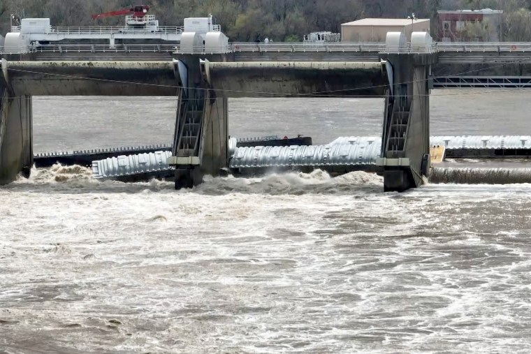 A barge that broke free from a tugboat on the Ohio River in Louisville, Ky., remained pinned against structures Tuesday.