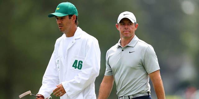 Rory McIlroy of Northern Ireland and his caddie Harry Diamond react on the eighth green during the second round of the 2023 Masters Tournament at Augusta National Golf Club April 7, 2023, in Augusta, Ga.