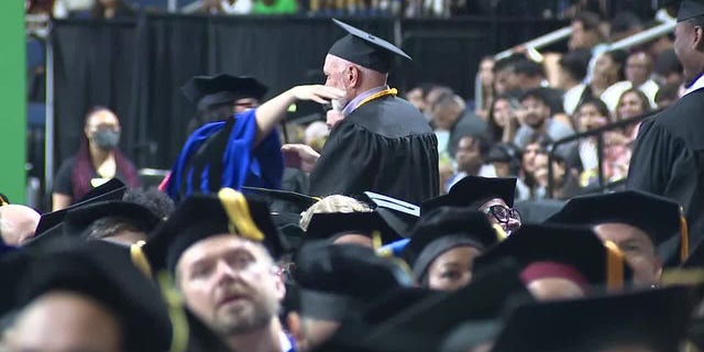 Sam Kaplan hugging person at his graduation