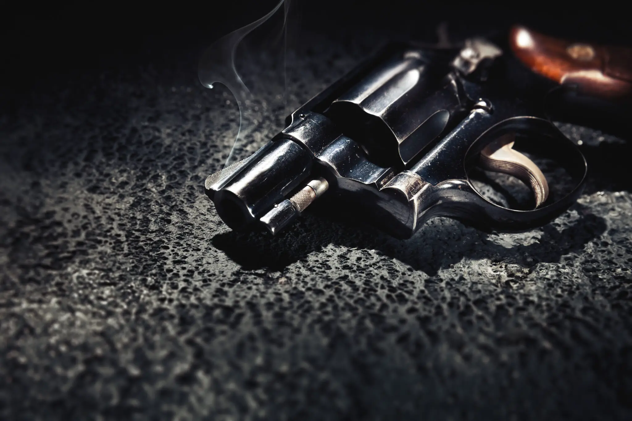 gun with smoke on the floor, high contrast image