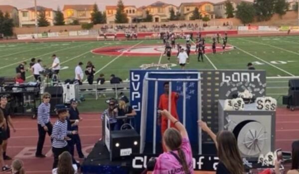 redominantly White High School Choses ‘Cops and Robbers’ Themed Homecoming Float with Black Male Student in Orange Jumper Behind Bars As Winner of Parade