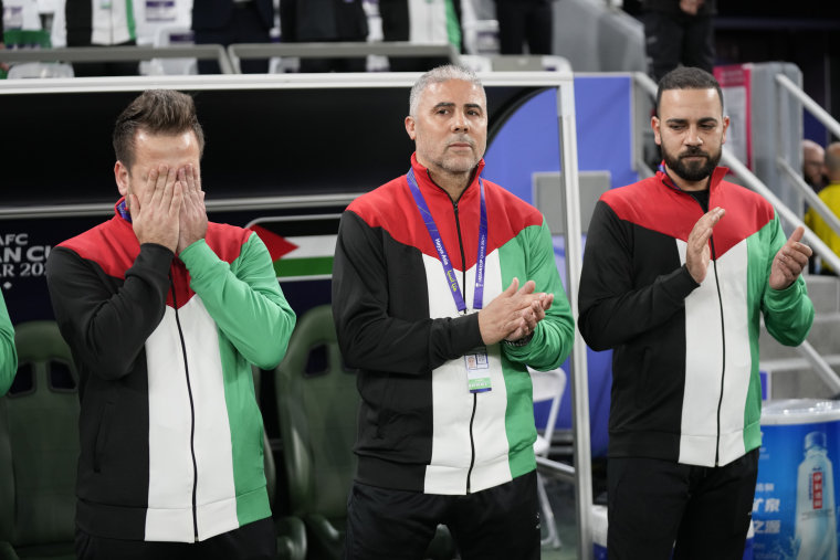 Palestine's head coach Makram Daboub, center, applauds ahead of the match between Iran and Palestine at the Education City Stadium in Al Rayyan, Qatar, Sunday, Jan. 14, 2024. 