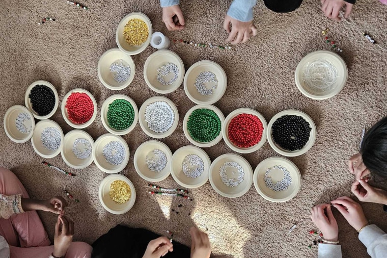 Girl scout troop making bracelets to support humanitarian crisis in Gaza.